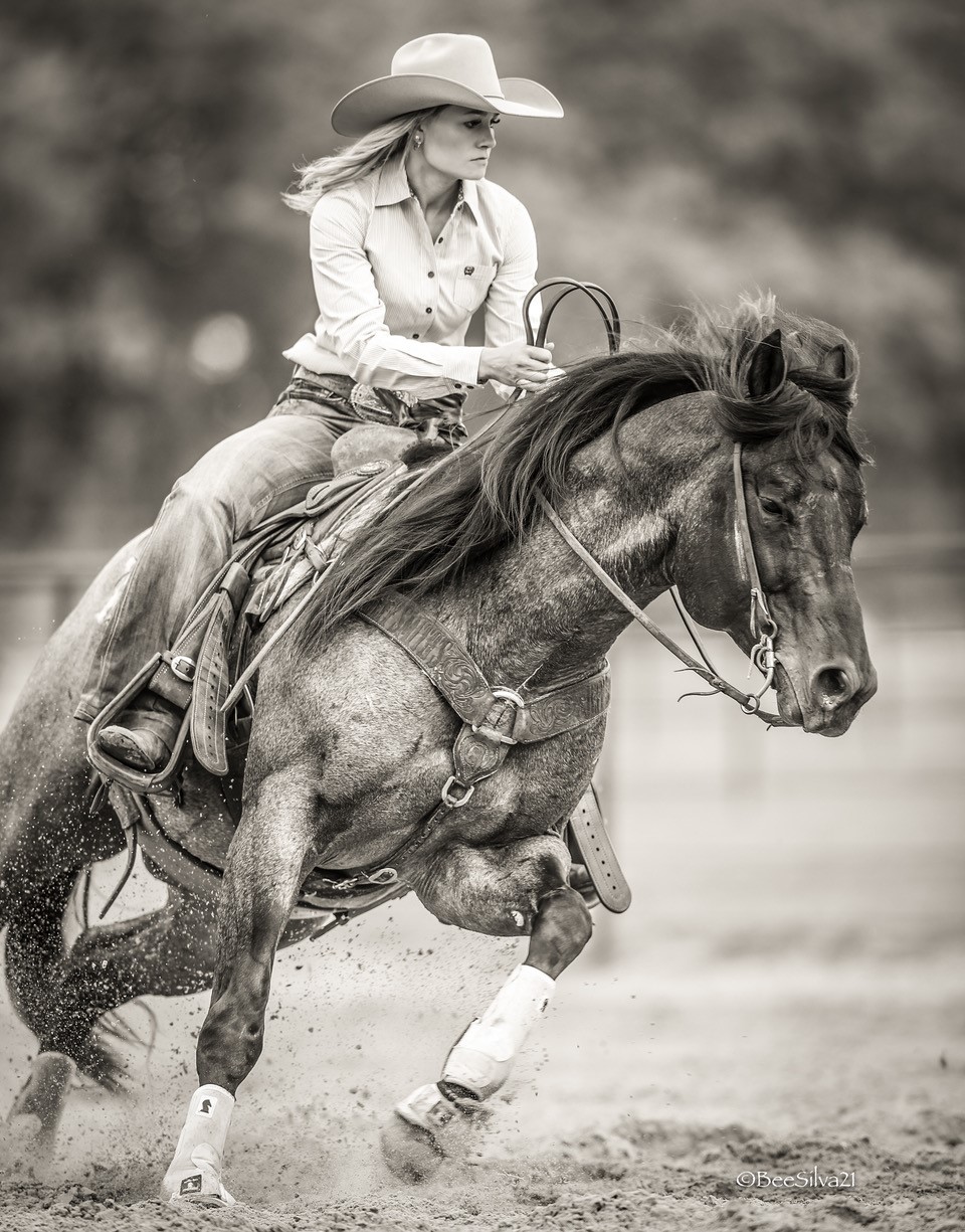 black-and-white photo of woman riding a horse