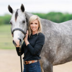 Sherry Johnson standing with gray and white horse