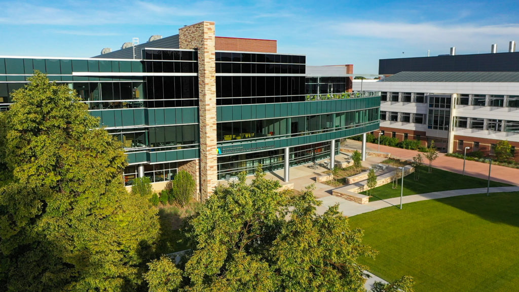 glass front Translational Medicine Institute building, arial view with trees in bottom left corner