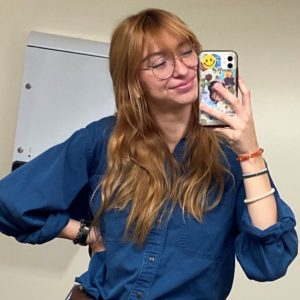 Girl with phone in hand taking selfie in the mirror
